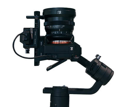 A video camera points towards the sky, connected to a stabilizing gimbal.